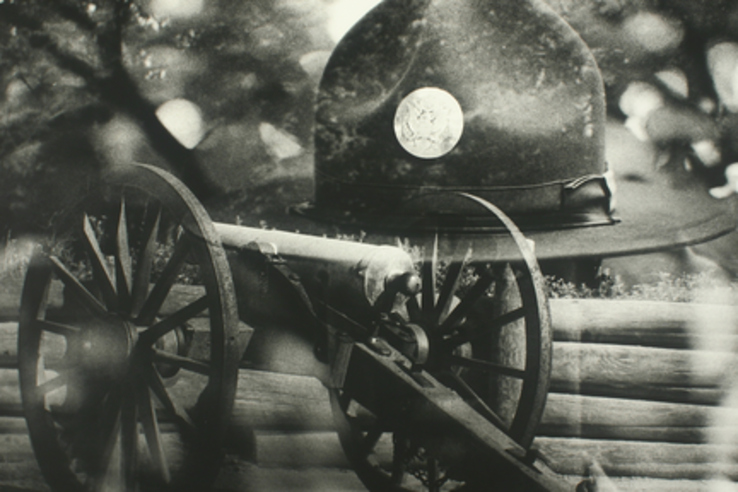 Civil War Artifact | Movies Fan Club A Civil War-era cannon and soldier's hat sit near a bench, evoking classic films set in historical periods.