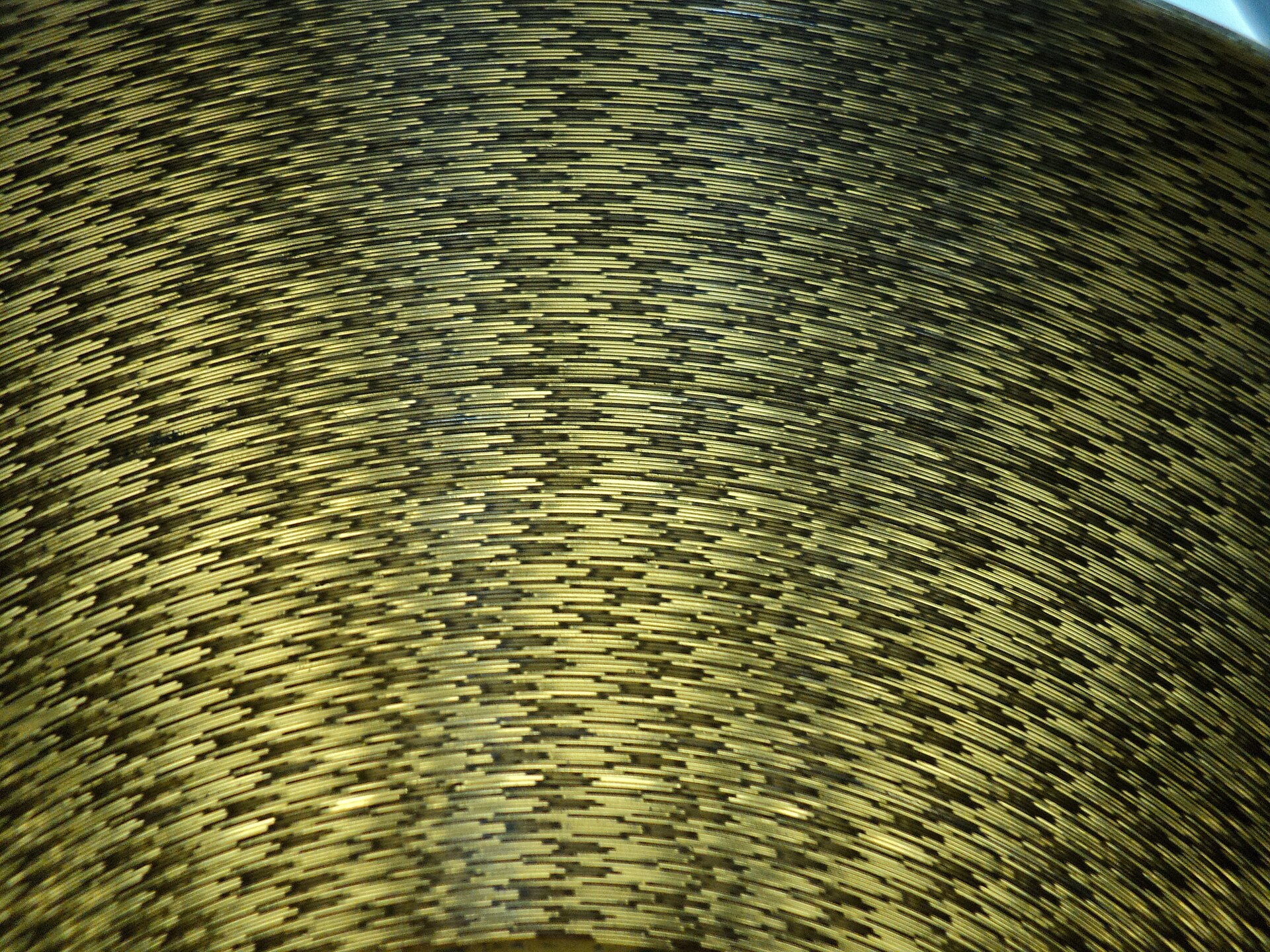 Film Stock Decay | Movies Fan Club Golden metallic tiles form a curved architectural detail, representing the beauty and fragility of classic film.
