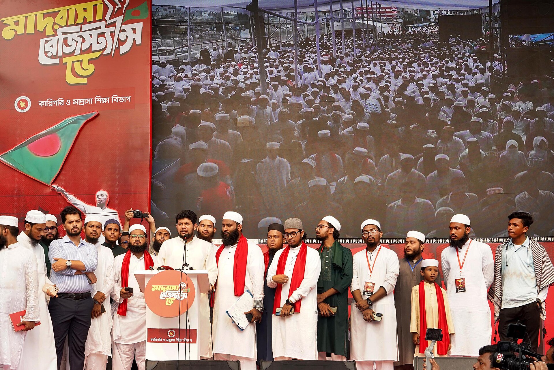 A group of men wearing traditional Islamic clothing stand on a stage, representing cultural diversity in cinema.